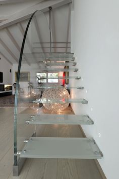 a curved glass shelf in the middle of a room