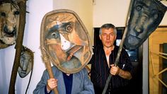 two men with masks on their faces holding paddles