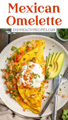 mexican omelette on a plate with avocado and sour cream in the background