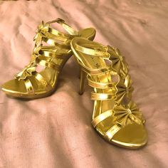 Brand New, Never Worn Sexy Gold Strappy Sandal Style, With Bows. 4 Inch Heels, Very Sturdy. 1/2 Inch Platform At Toes. Strap Buckles Around Your Ankle. Fitted Gold Strappy Heels, Fitted Synthetic Heels For Party Season, Gold Synthetic Heels For Party, Gold Synthetic Heels For Night Out, Fitted Gold Synthetic Sandals, Gold Strappy Sandals, Gold High Heels, Sandal Style, Evening Shoes