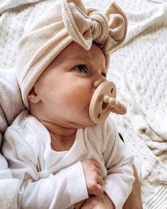 a baby with a pacifier in its mouth