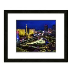 an aerial view of the las vegas strip at night framed in black wood with white mat