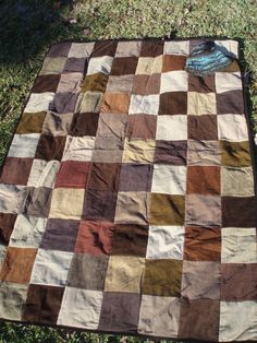 an old patchwork quilt on the grass