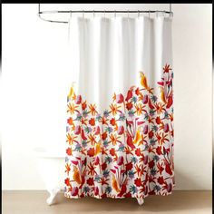 the shower curtain is decorated with colorful flowers and birds in red, orange, yellow and white