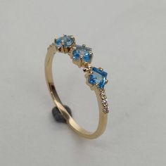 **KINDLY CHECK OUT THE VIDEO OF THE ITEM FOR A CLEARER VIEW**Details of the ring Gemstone: Diamond gem shape & weight: Round, ( 6 piece ) & 0.05 carats Swiss Blue Topaz Square 3 mm (3 piece) Weight 0.60 carats Metal: GOLD Purity: 14 KT Weight: 1.17 Grams Total weight of the ring: 1.30 grams Beautiful fine cut Natural Diamond VVS-VS PURITY & I-J color with Swiss Blue Topaz set in 14kt Gold ring, a perfect gift for a woman. Attached IGI lab DIAMOND certificate. The Gold purity is absol Topaz Diamond Ring, Rhodolite Garnet Ring, Ruby Ring Gold, Alternative Engagement Ring, Rosecut Diamond Ring, Topaz Jewelry, Alternative Engagement Rings, Swiss Blue Topaz, Gold Price