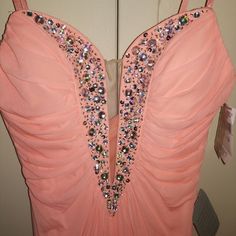 a pink dress with sequins and beads on it