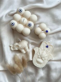 an assortment of fake objects on a white sheet with blue eyes and other things to make it look like they are made out of clay