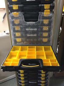 a large tool box filled with yellow and black tools