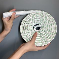 a hand holding a roll of white and green fire retardant