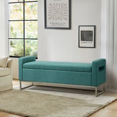 a living room with a couch, chair and rug on the hardwood floor in front of a window