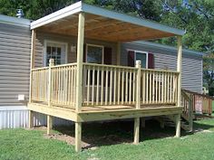 a mobile home with a porch and deck