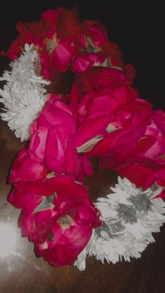 red and white flowers on a wooden table