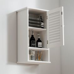 a white shelf with bottles and other items on it