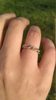 a person's hand with a ring on it