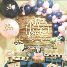 a baby shower party with balloons and desserts