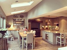 a kitchen filled with lots of white furniture