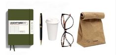 the contents of a travel bag, coffee cup, and eyeglasses are shown