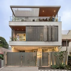 a modern house with an elevated deck and balcony