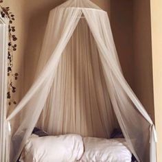 a bed with a white canopy over it