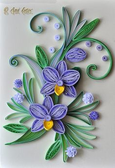 an artistically designed card with purple flowers and green leaves on it's side