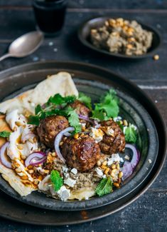 a plate with meatballs and vegetables on it