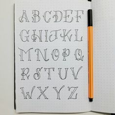 a notebook with some writing on it and a pencil in front of the letter's lowercases