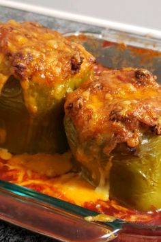 two stuffed peppers in a casserole dish