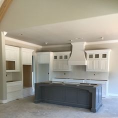 an empty kitchen with white cabinets and gray counter tops in the middle of it's remodeling process