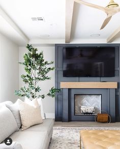 the living room is clean and ready to be used as a tv over the fireplace