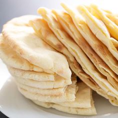 a stack of pancakes sitting on top of a white plate