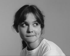 a black and white photo of a woman with her eyes wide open looking at the camera