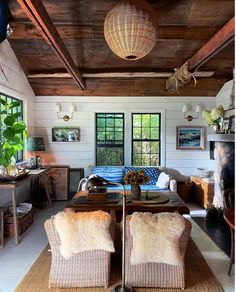 a living room filled with furniture and lots of windows