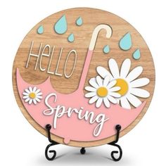 a wooden sign that says hello spring with daisies and raindrops on it