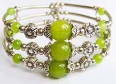 a close up of a bracelet with green beads