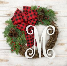 a christmas wreath with the letter m on it