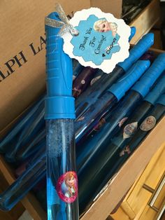 there is a blue plastic pen with a frozen princess sticker on it in a box