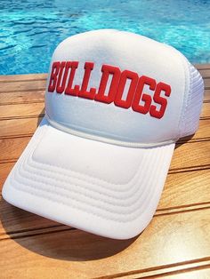 Super fun trucker hats that can be customized with your team name, mascot, phrase and more!   They are created with puff embossed print and look fantastic in our huge assortment of puff colors. Hat Colors:  All Black, All White, Black Back with White Front, Red, Navy, Khaki Closure: The back is an adjustable snap back Please List: 1. Text Style (Font 1, Font 2, Font 3, Athletic) ** please reach out first if you have a custom text or logo. 2. Text on Hat (8-10 characters) ** the more characters t Cheap Letter Print Trucker Hat For Fans, Sporty Flat Brim Trucker Hat For Fan Merchandise, Game Day Trucker Hat With Embroidered Logo, White Curved Brim Trucker Hat For College, Trucker Cap With Embroidered Logo For Fans, Fan Gear Trucker Hat With Embroidered Logo, White Flat Brim Trucker Hat For Game Day, Sporty Flat Brim Trucker Hat For Game Day, Trucker Baseball Cap For Sports Events With Flat Brim