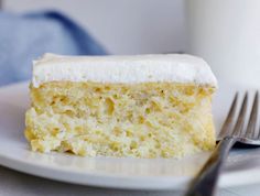 a piece of cake with frosting and a fork stuck in it on a plate