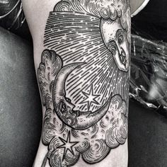 a black and white photo of a person's leg with a tattoo on it