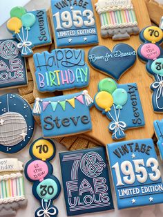 decorated cookies are arranged on a table for a 50th birthday cake and cookie decorating contest