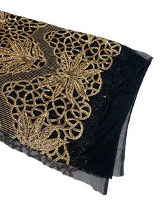 black and gold sequins on sheer fabric with metallic threadwork, closeup