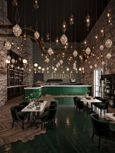 a restaurant with green walls and lights hanging from the ceiling