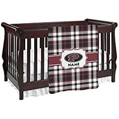 a baby crib bedding set with a name on it and a plaid pattern