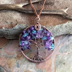 "This listing is for the Amethyst/Apatite Tree of Life Pendant Necklace. This lovely Tree is wire wrapped with Amethyst & Apatite gemstones using an antiqued copper wires for the outer ring and the tree trunk and branches. ~~The pendant measures about between 1.50 to 1.60 inch in diameter. It comes with your choice of cable chain. ~~ Each pendant is handmade, so please allow slight variations from the shape of the branches and placement of the stones as shown Introducing Deerskin Lace Leathe Blue Amethyst Crystal Necklace For Gift, Handmade Fluorite Necklaces For Gift, Bohemian Amethyst Birthstone Necklace, Handmade Blue Amethyst Crystal Necklaces, Amethyst Crystal Necklaces With Natural Stones, Handmade Blue Amethyst Crystal Necklace, Amethyst Crystal Necklace With Natural Stones, Round Amethyst Crystal Necklaces With Natural Stones, Handmade Round Fluorite Jewelry