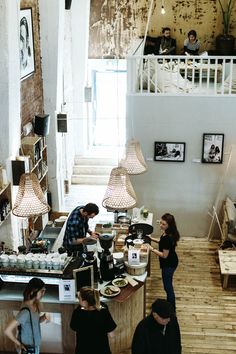 people are standing around in a small coffee shop