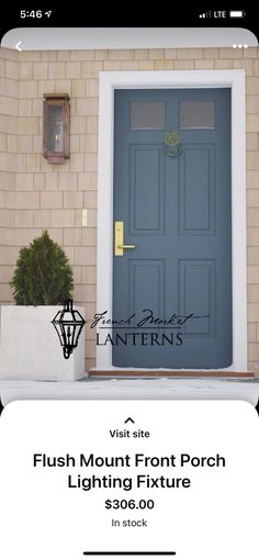 a blue front door with two planters on the side