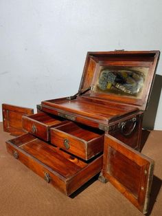 an old wooden chest with three drawers and a mirror in the top one is open