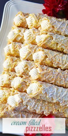 a white plate topped with lots of desserts covered in icing and powdered sugar