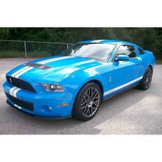 a blue mustang parked in a parking lot