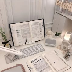 an open book sitting on top of a desk next to a keyboard and mouse,